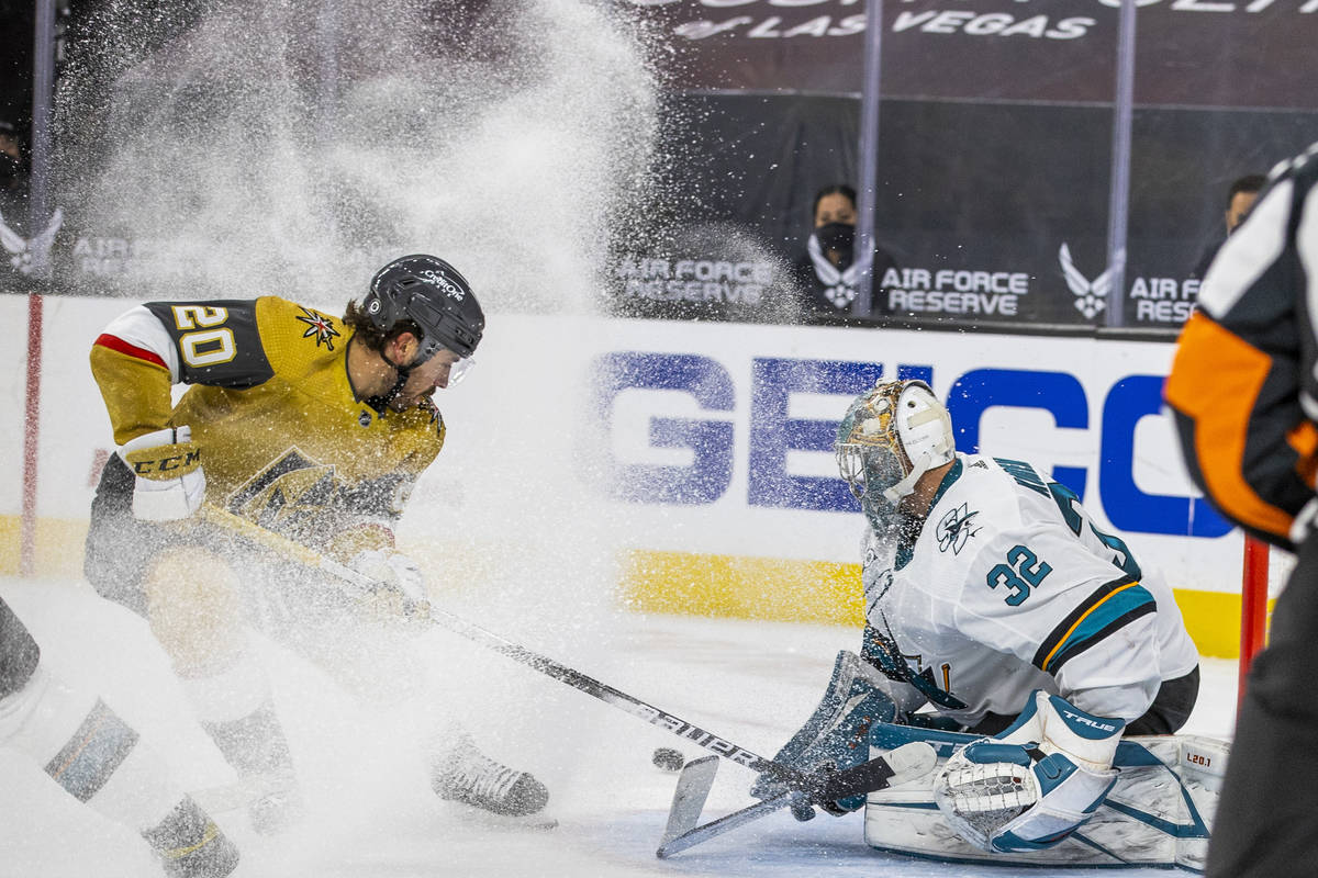 Golden Knights center Chandler Stephenson (20) kicks up some ice shaving as he attempts a shot ...