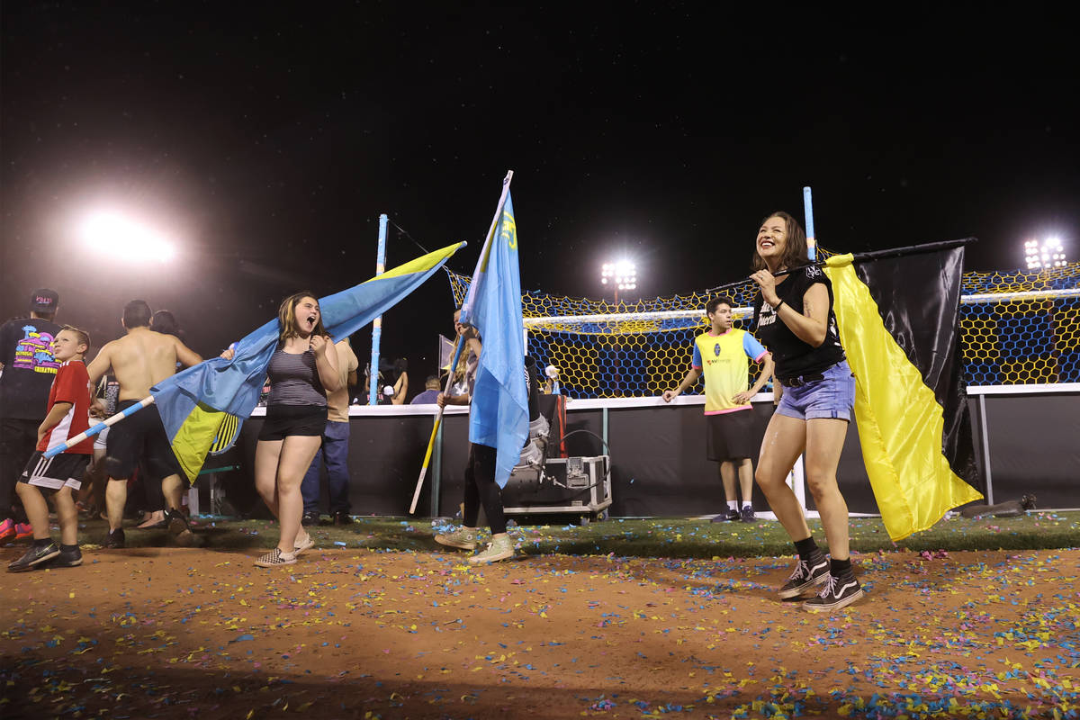 Fans take the field at the end of a USL Championship soccer game between the Las Vegas Lights a ...