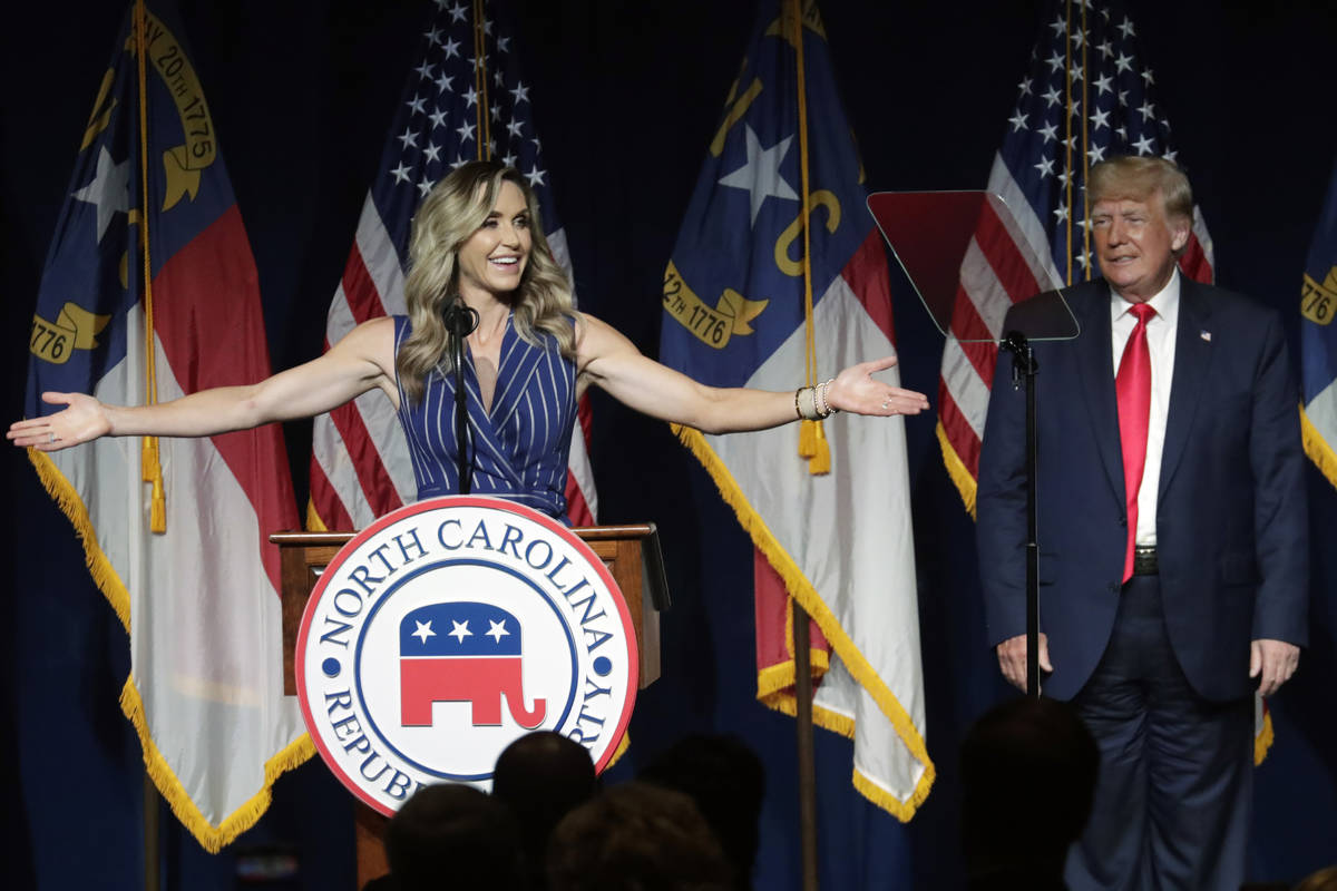 Former President Donald Trump, right, listens as his daughter-in-law Lara Trump speaks at the N ...