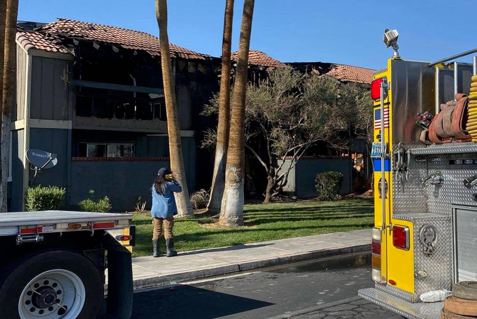 Fire damage to a roof can be seen as Clark County and Las Vegas firefighters battle a fire at t ...