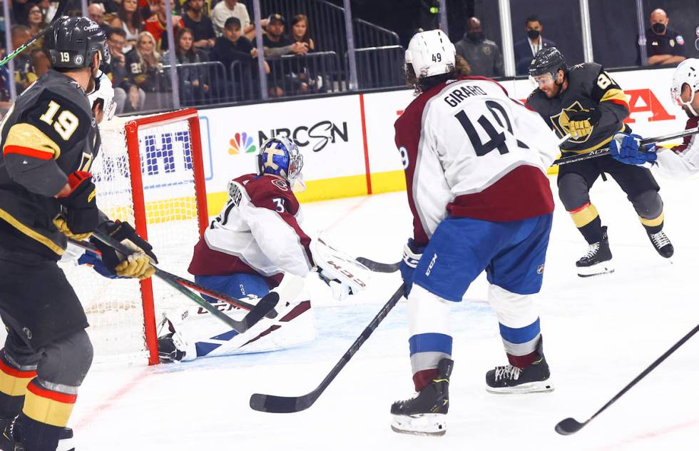 Golden Knights' Jonathan Marchessault, right, gets the puck past Colorado Avalanche goaltender ...