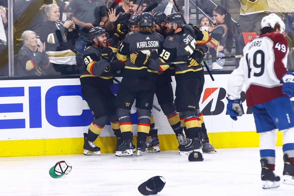 Golden Knights' Jonathan Marchessault, left, is mobbed by teammates after scoring a hat trick i ...