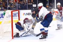 Golden Knights' Patrick Brown (38) fights to get the puck past Colorado Avalanche goaltender Ph ...