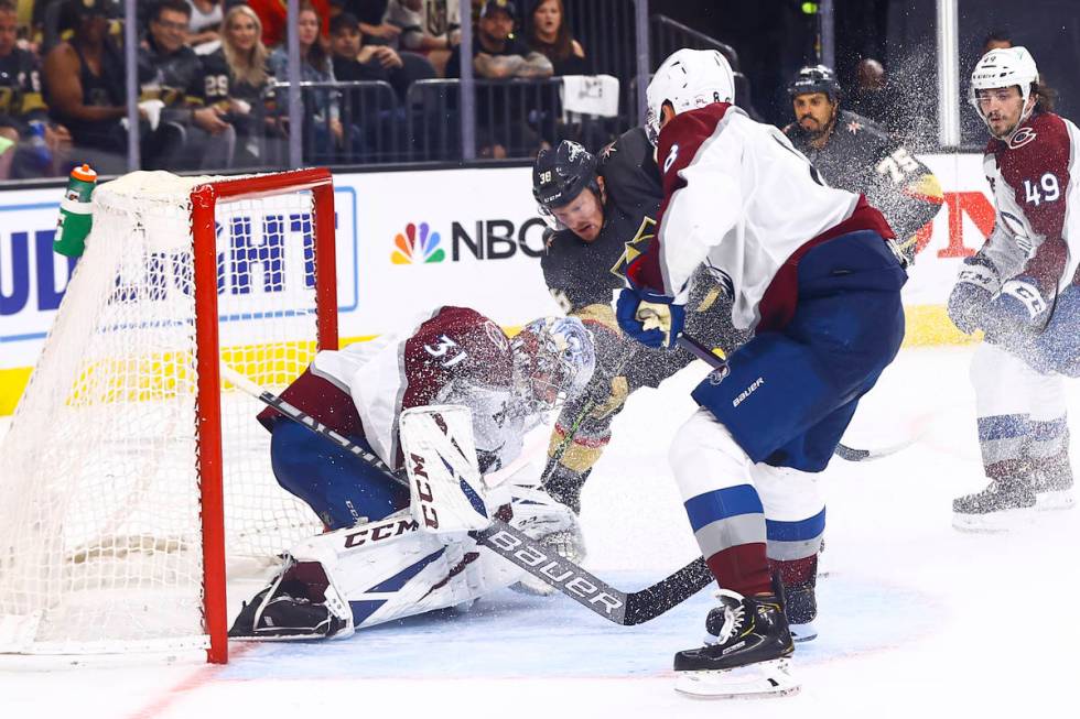 Golden Knights' Patrick Brown (38) fights to get the puck past Colorado Avalanche goaltender Ph ...