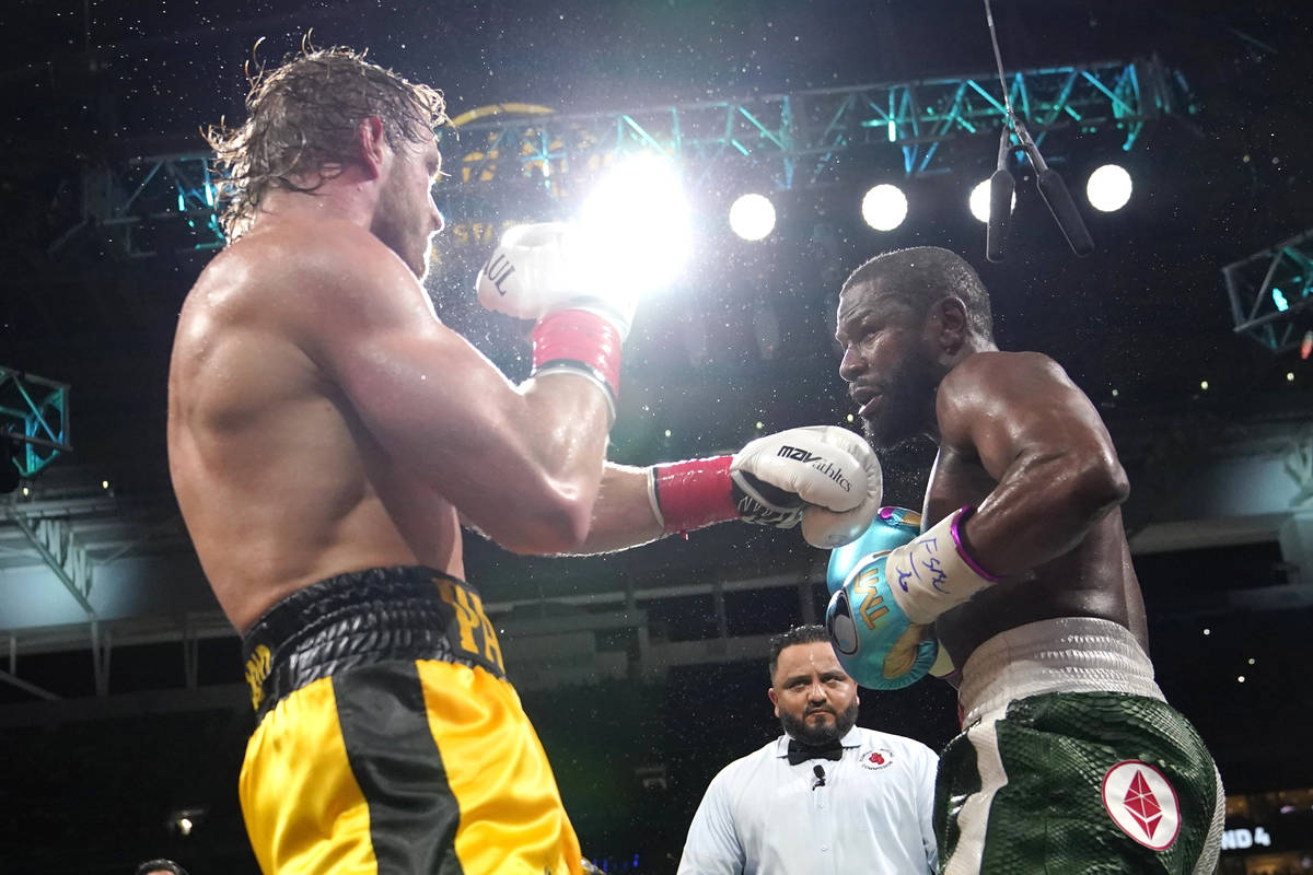 Logan Paul, left, and Floyd Mayweather fight during an exhibition boxing match at Hard Rock Sta ...