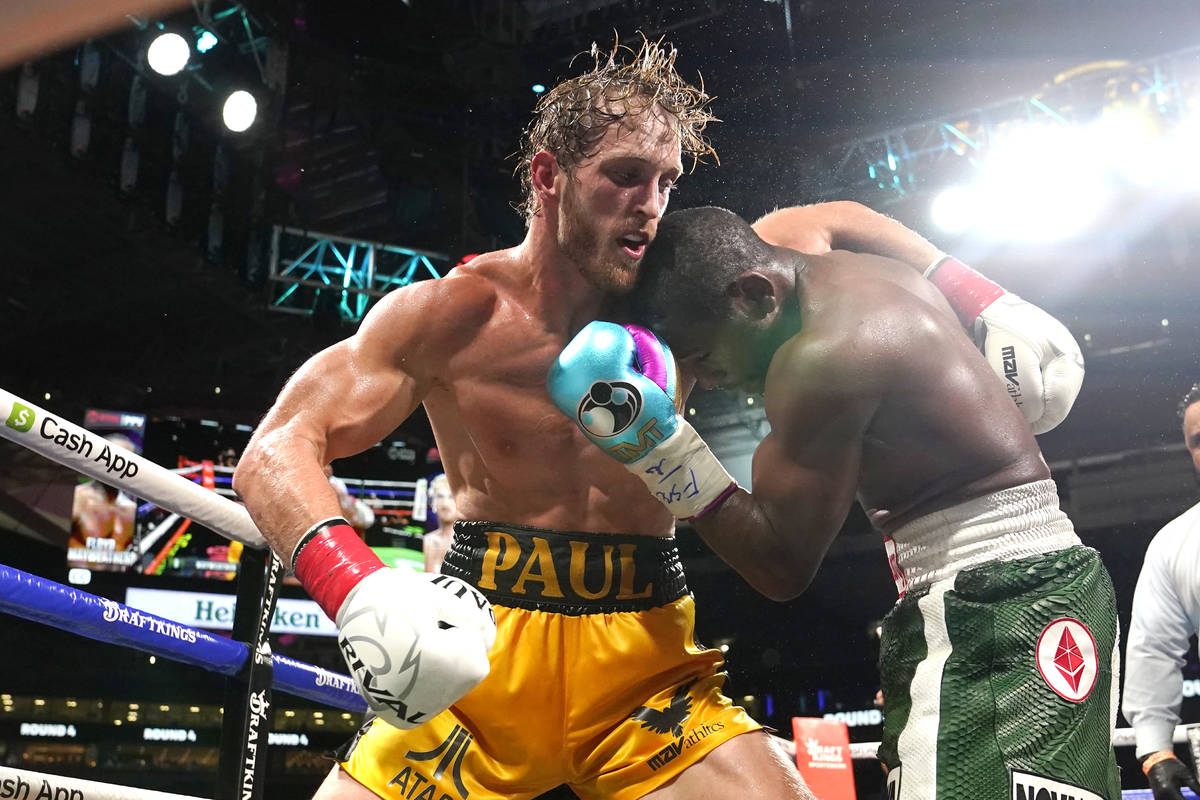 Logan Paul, left and Floyd Mayweather fight during an exhibition boxing match at Hard Rock Stad ...