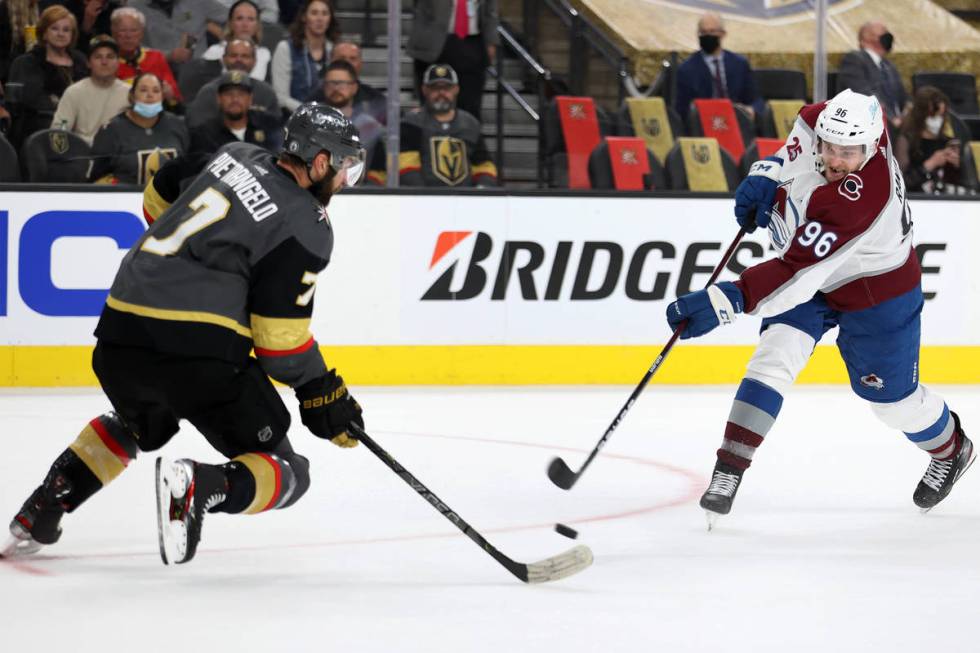 Colorado Avalanche right wing Mikko Rantanen (96) takes a shot under pressure from Vegas Golden ...