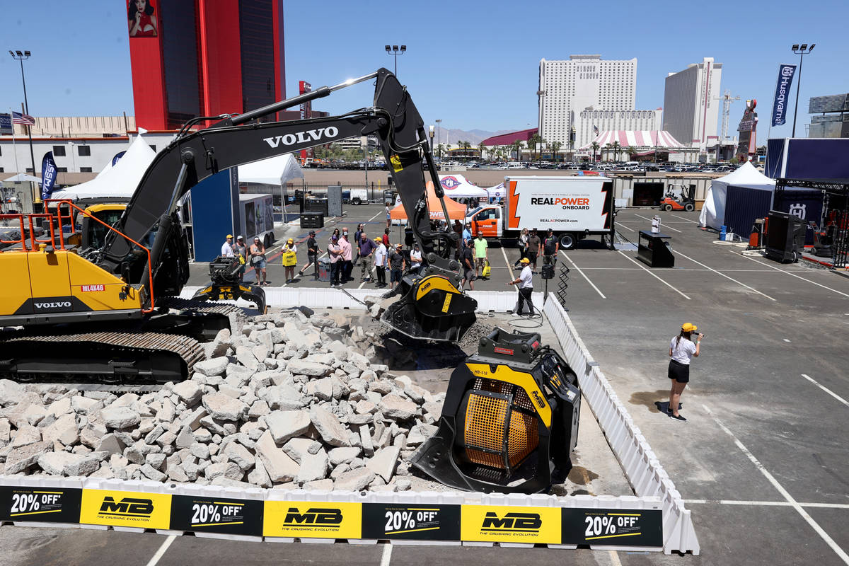 Conventioneers check out the MB Crusher America booth at the World of Concrete trade show outsi ...
