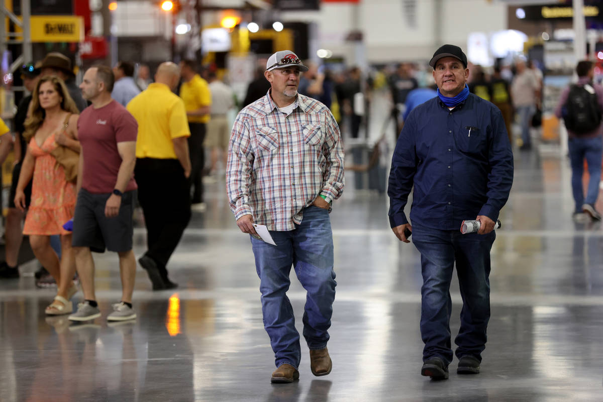 Conventioneers Matt Sierras, left, and Max Soto of Tucson, Ariz. walk the show floor at the Wor ...