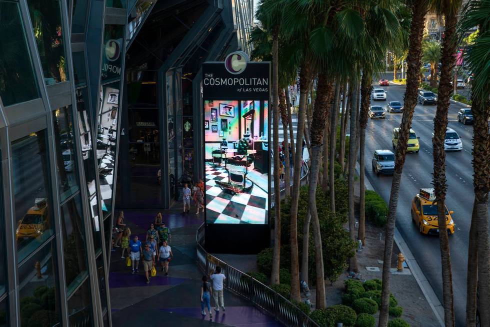 Pedestrians and traffic pass Cosmopolitan of Las Vegas on Wednesday, June 9, 2021 in Las Vegas. ...