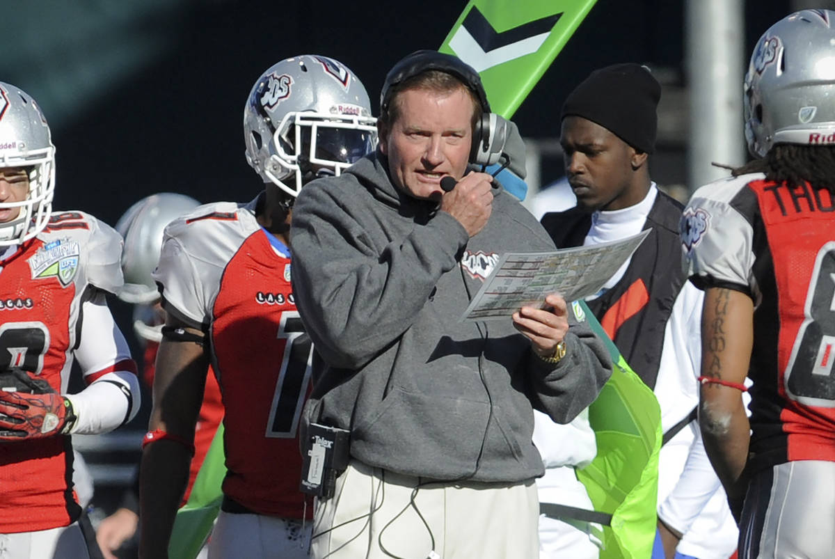 In this Nov. 27, 2010, file photo, then Las Vegas head coach Jim Fassel, center, looks on from ...