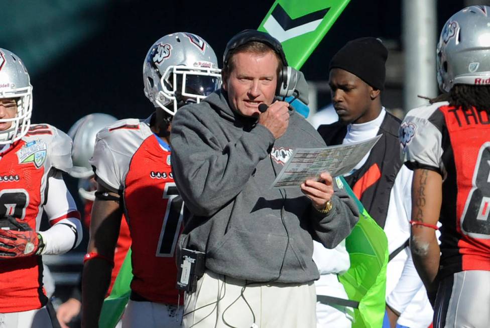 In this Nov. 27, 2010, file photo, then Las Vegas head coach Jim Fassel, center, looks on from ...