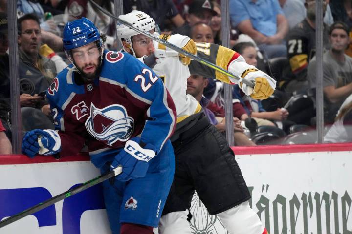 Vegas Golden Knights center Nicolas Roy, right, cheks Colorado Avalanche defenseman Conor Timmi ...