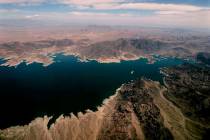 Lake Mead, which separates Arizona, bottom, and Nevada, top, is seen from the air, east of Las ...