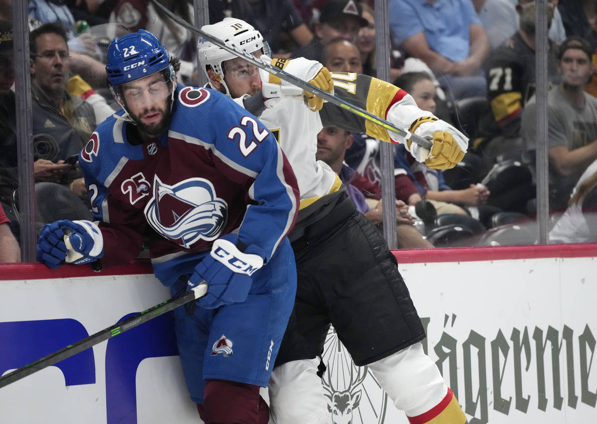 Vegas Golden Knights center Nicolas Roy, right, cheks Colorado Avalanche defenseman Conor Timmi ...