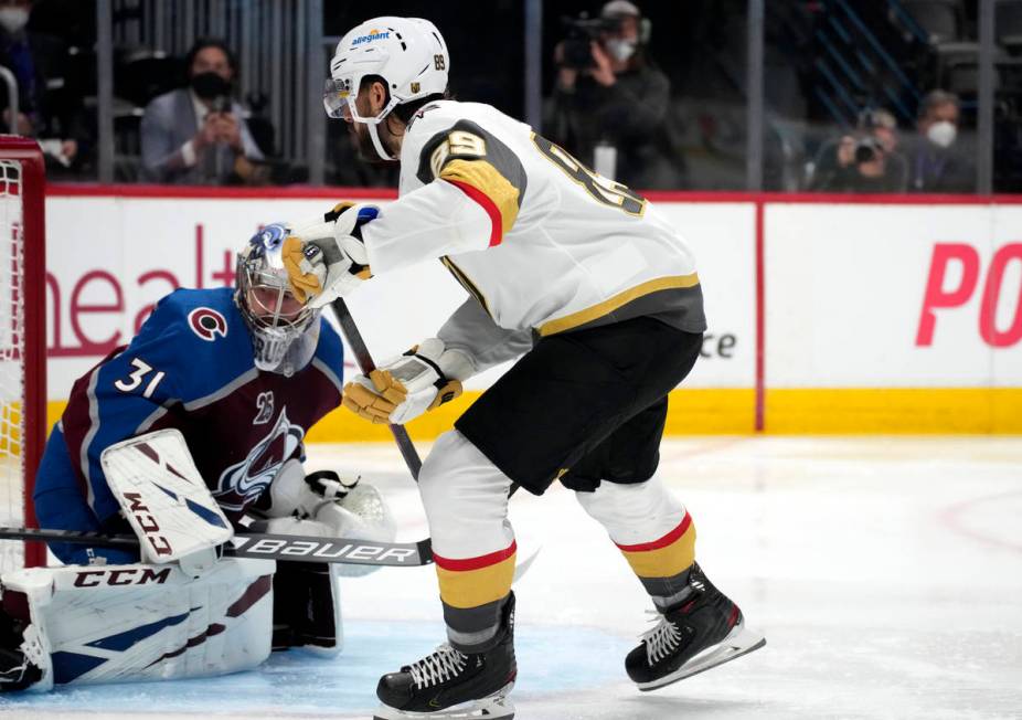 Vegas Golden Knights right wing Alex Tuch, right, scores a goal past Colorado Avalanche goalten ...