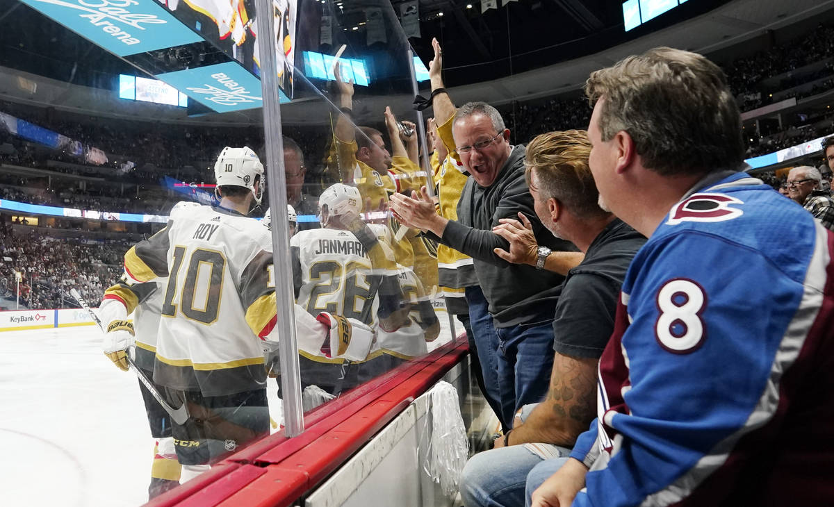 As members of the Vegas Golden Knights, left, celebrate a a goal by center Jonathan Marchessaul ...