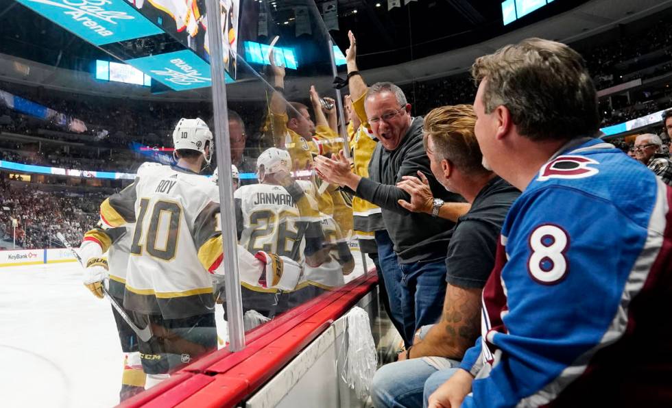 As members of the Vegas Golden Knights, left, celebrate a a goal by center Jonathan Marchessaul ...