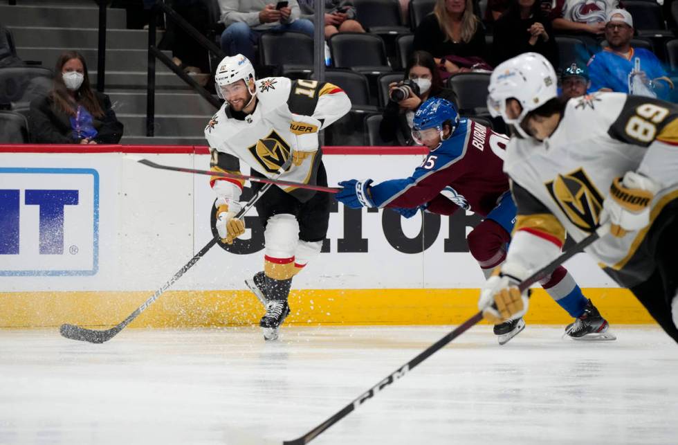 Vegas Golden Knights center Nicolas Roy, left, lifts a pass to right wing Alex Tuch, front, as ...