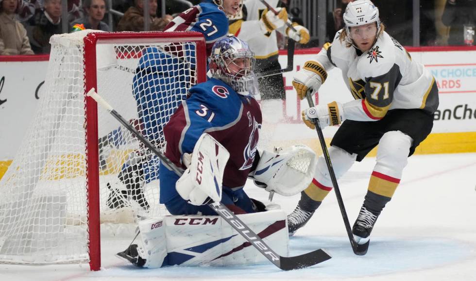 Colorado Avalanche goaltender Philipp Grubauer, left, stops a shot by Vegas Golden Knights cent ...