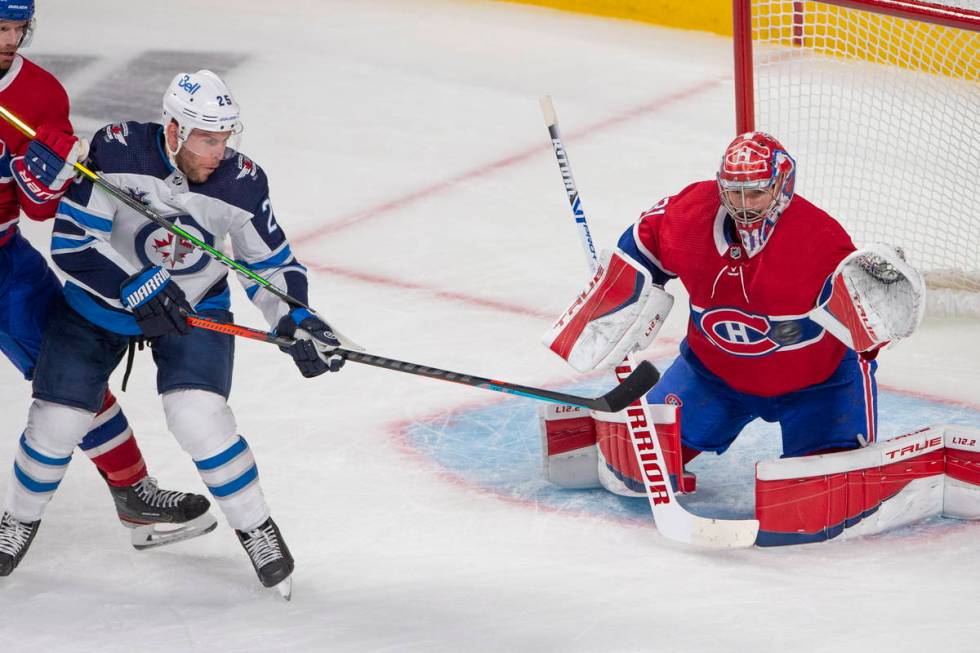 Montreal Canadiens goaltender Carey Price (31) keeps his eye on the puck as he stops Winnipeg J ...