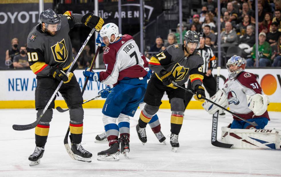 Golden Knights center Nicolas Roy (10) deflects a shot past Colorado Avalanche defenseman Devon ...