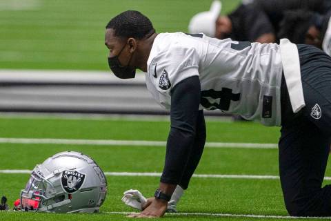 Las Vegas Raiders defensive back Kemah Siverand (34) wears a mask while stretching during a pra ...