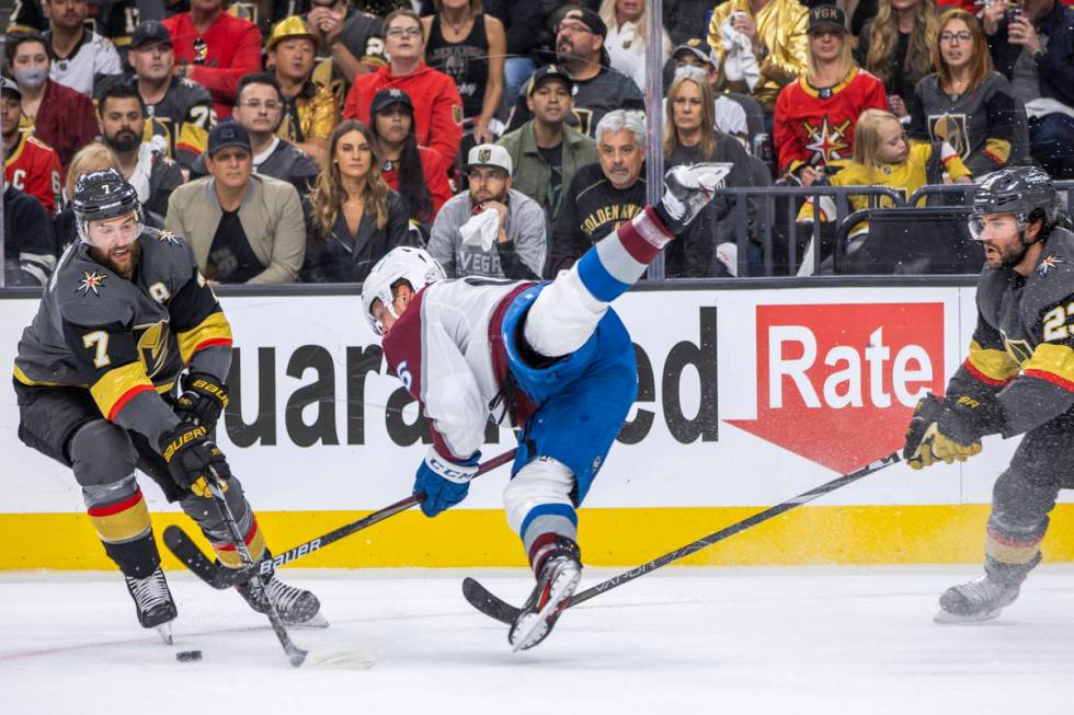 Colorado Avalanche right wing Mikko Rantanen (96) is upended between Golden Knights defenseman ...