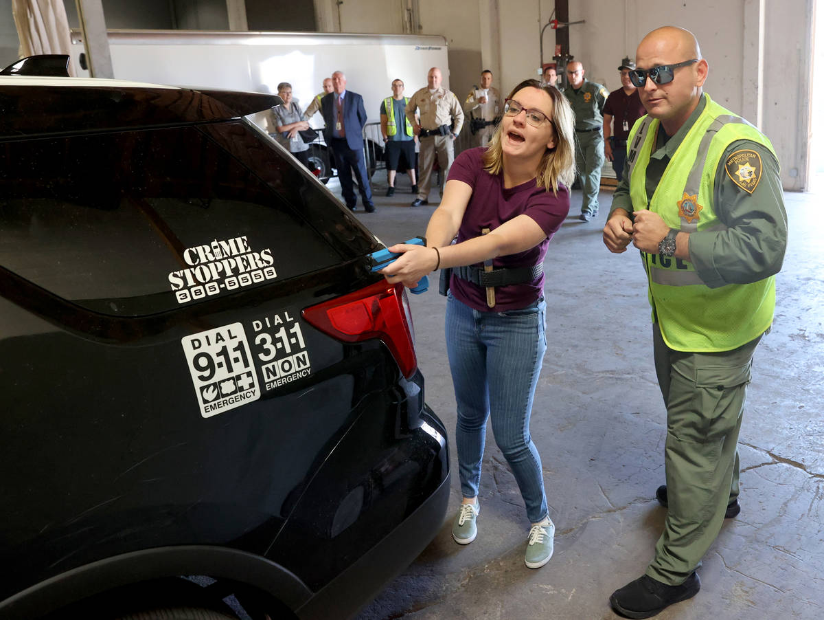 Las Vegas Review-Journal reporter Katelyn Newberg gives instructions to a suspect with Las Vega ...