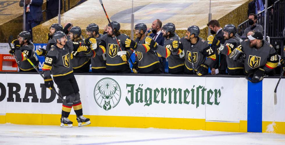 Golden Knights defenseman Nick Holden (22) celebrates his goal with teammates during the first ...