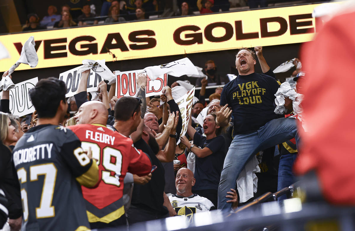 Entertainer Cameron Hughes, right, hypes up the crowd during the third period of Game 4 of an N ...