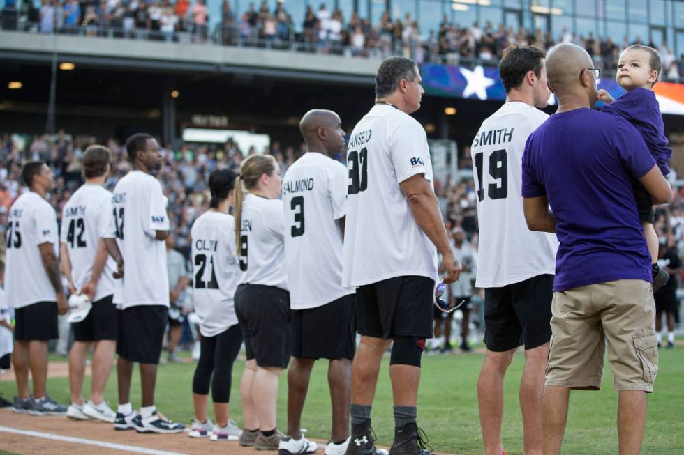 Jordan Rey, 2, right, looks up at the crowd during the playing of the national anthem before th ...