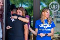 Angela Ahmet, center, hugs Rob Hutchinson, President of the Southern Nevada Bicycle Coalition, ...