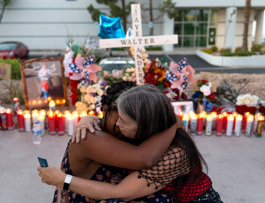 Joan Anderson, right, Walter Anderson's sister, hugs Charis Jimmons, his neighbor, at a vigil ...