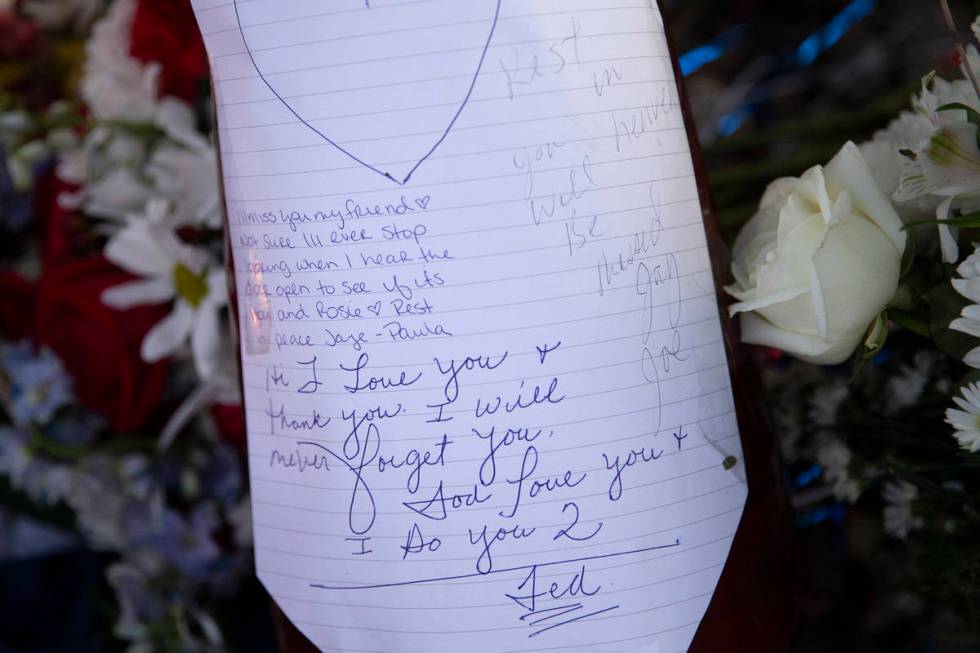 Loving notes are written at a vigil for Walter Richard Anderson near the intersection where he ...