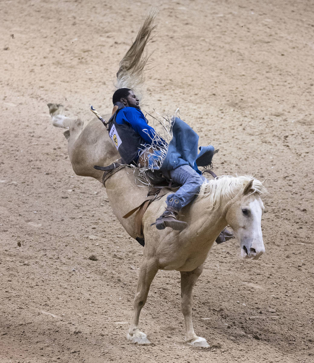 Tre Hosley, of Compton, Calif., rides Trigger while competing in bareback riding at the Bill Pi ...