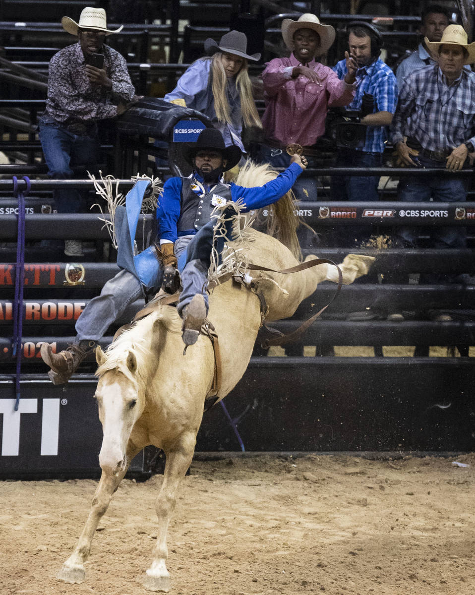Tre Hosley, of Compton, Calif., rides Trigger while competing in bareback riding at the Bill Pi ...
