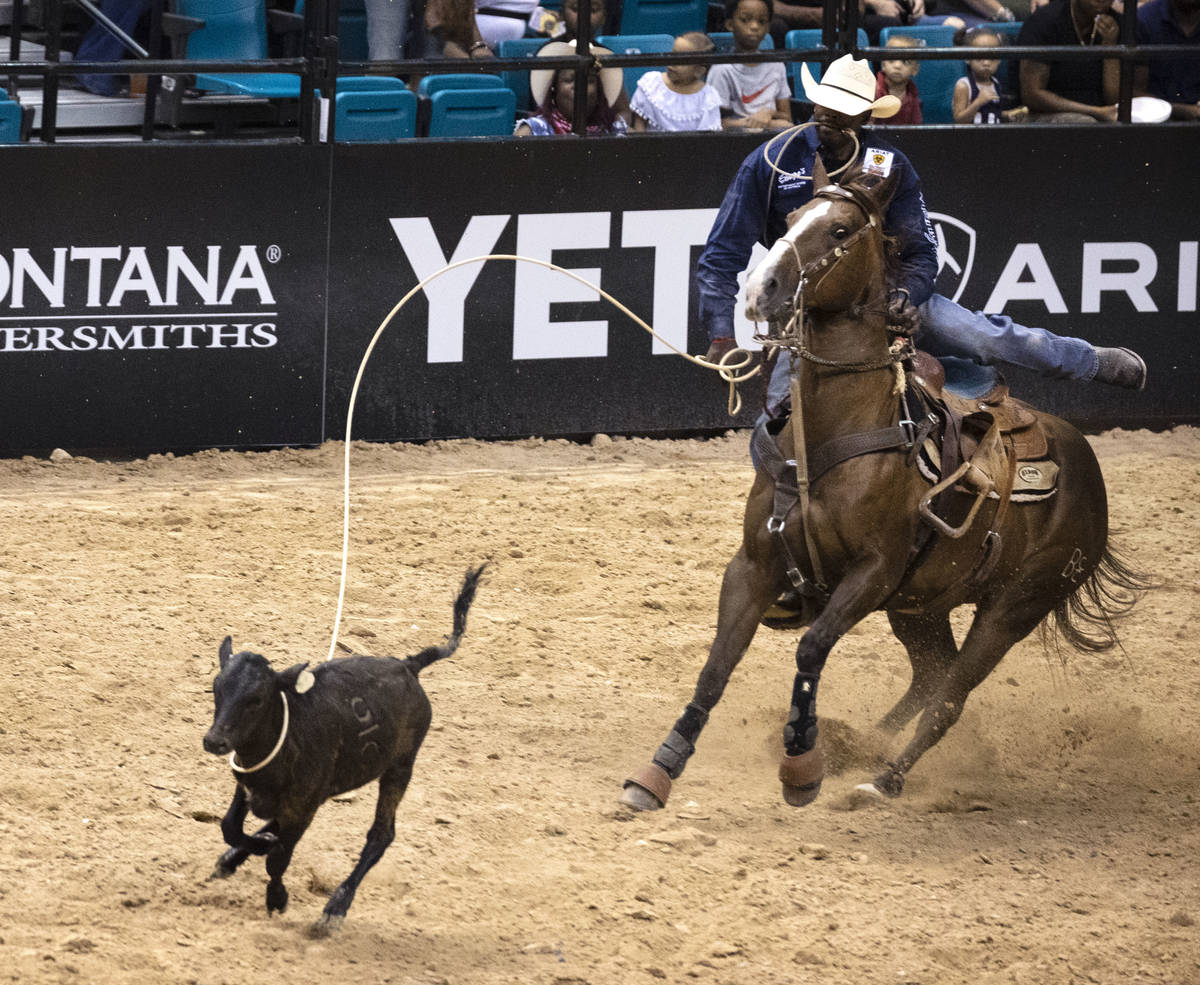 Jeremy Burkhalter, of Houston, Texas, participates in calf roping competition at the Bill Picke ...