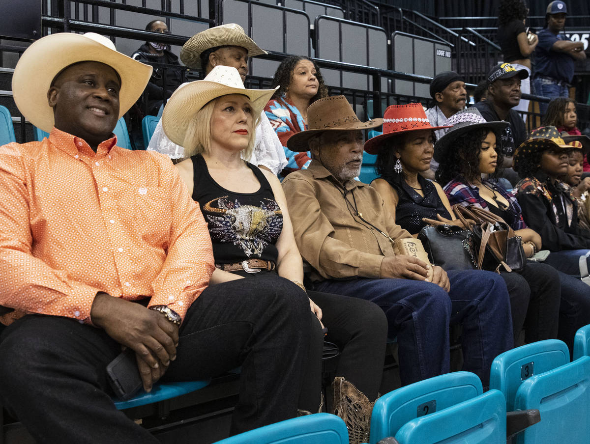 People, including Victor Locklin, left, Judy Santos, Darrell Porter and his wife Wanda watch th ...