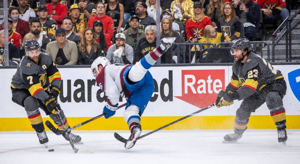 Colorado Avalanche right wing Mikko Rantanen (96) is upended between Golden Knights defenseman ...