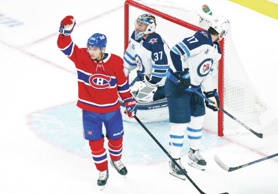 Montreal Canadiens' Nick Suzuki celebrates his goal past Winnipeg Jets goaltender Connor Helleb ...