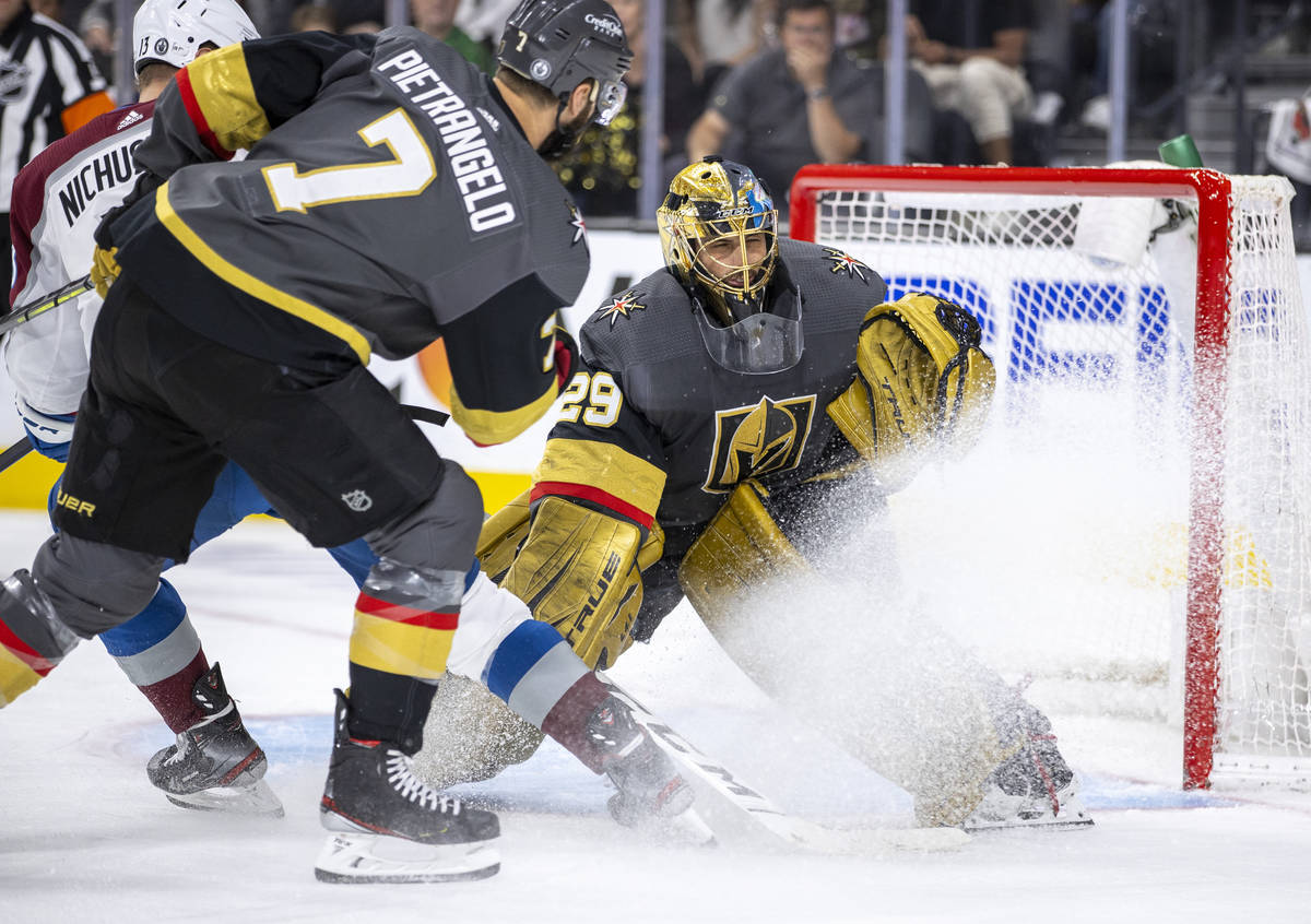 Golden Knights goaltender Marc-Andre Fleury (29) defends the net with help from teammate defens ...