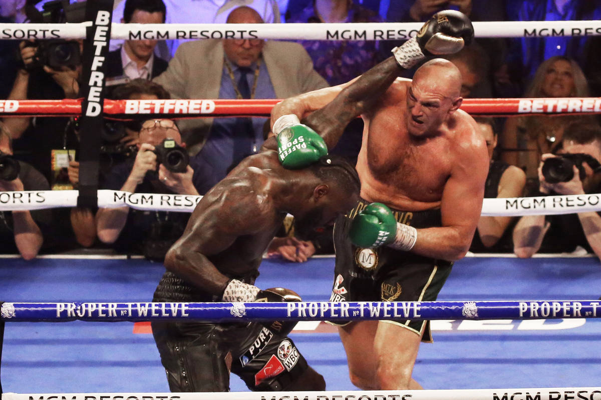 Tyson Fury, right, connects with a right hook against Deontay Wilder in the fifth round during ...