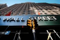 In this May 19, 2021 file photo, a sign for a Wall Street building is shown, Wednesday, May 19, ...