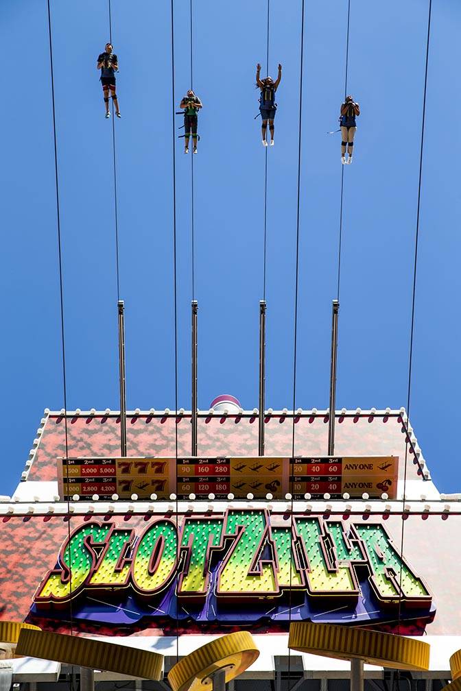 Slotzilla riders leave the platform for a run down the zipline at the Fremont Street Experience ...