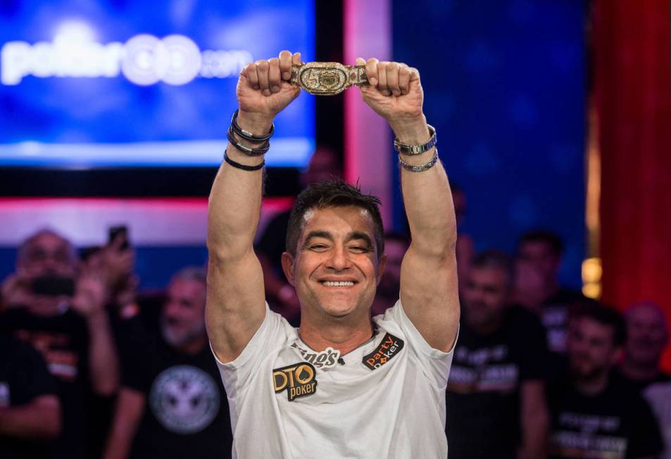 Hossein Ensan, from Germany, lifts the championship bracelet after winning the World Series of ...