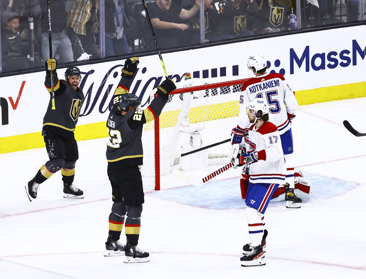 Golden KnightsÕ Nick Holden (22) celebrates his goal next to Jonathan Marchessault, left, ...