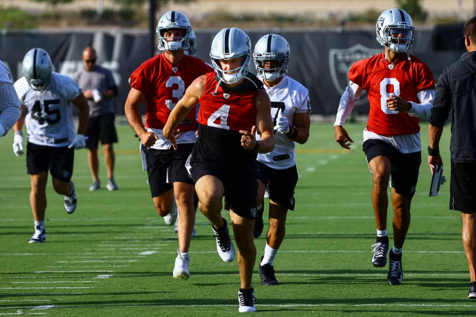 Raiders quarterback Derek Carr (4) warms up with teammates during an NFL football minicamp at R ...