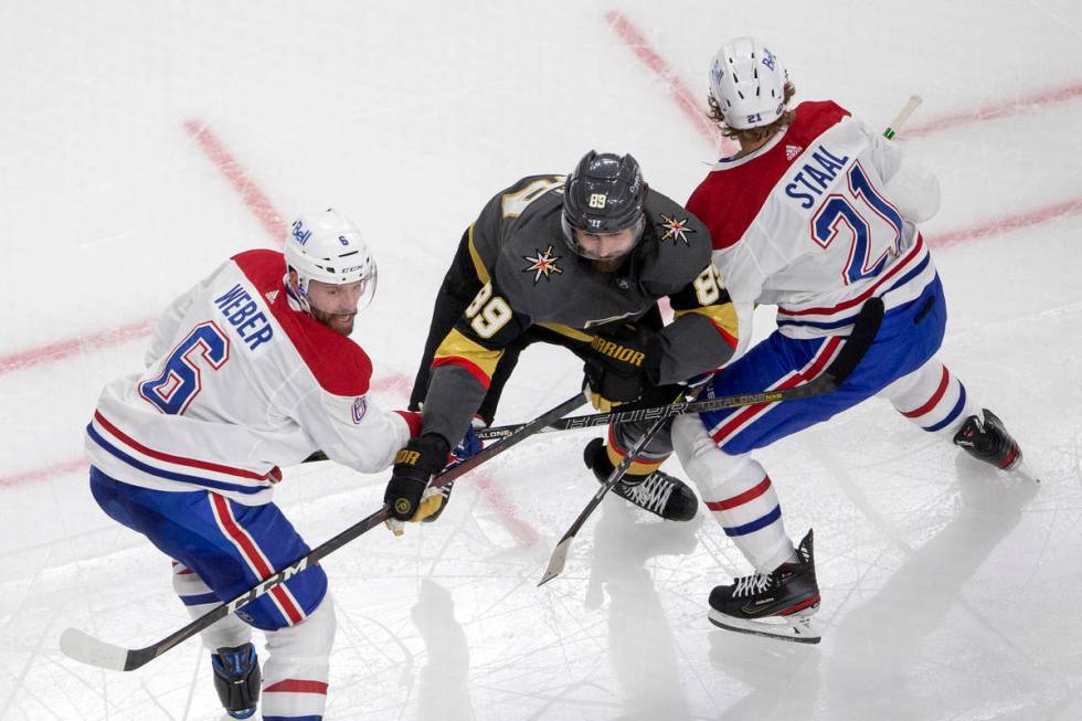 Canadiens defenseman Shea Weber (6) and center Eric Staal (21) block Golden Knights right wing ...