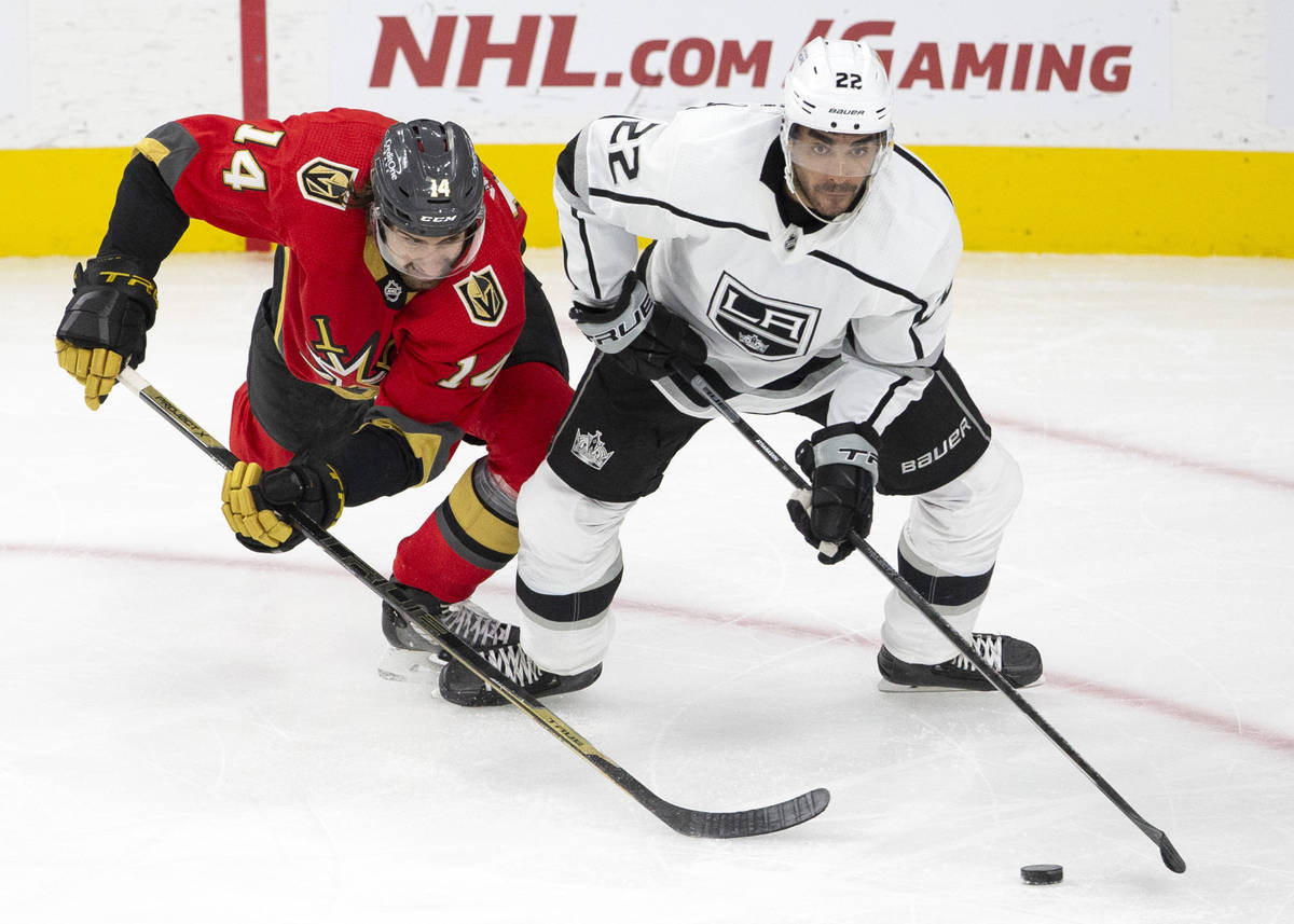 Golden Knights defenseman Nicolas Hague (14) and Kings left wing Andreas Athanasiou (22) compet ...